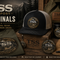 TSS Outpost Originals collection image featuring a branded snapback hat, logo t-shirt, camp mug, collectible patch, and notebook in a rustic mountain setting with the tagline Original Gear. Uncommon Ideas.
